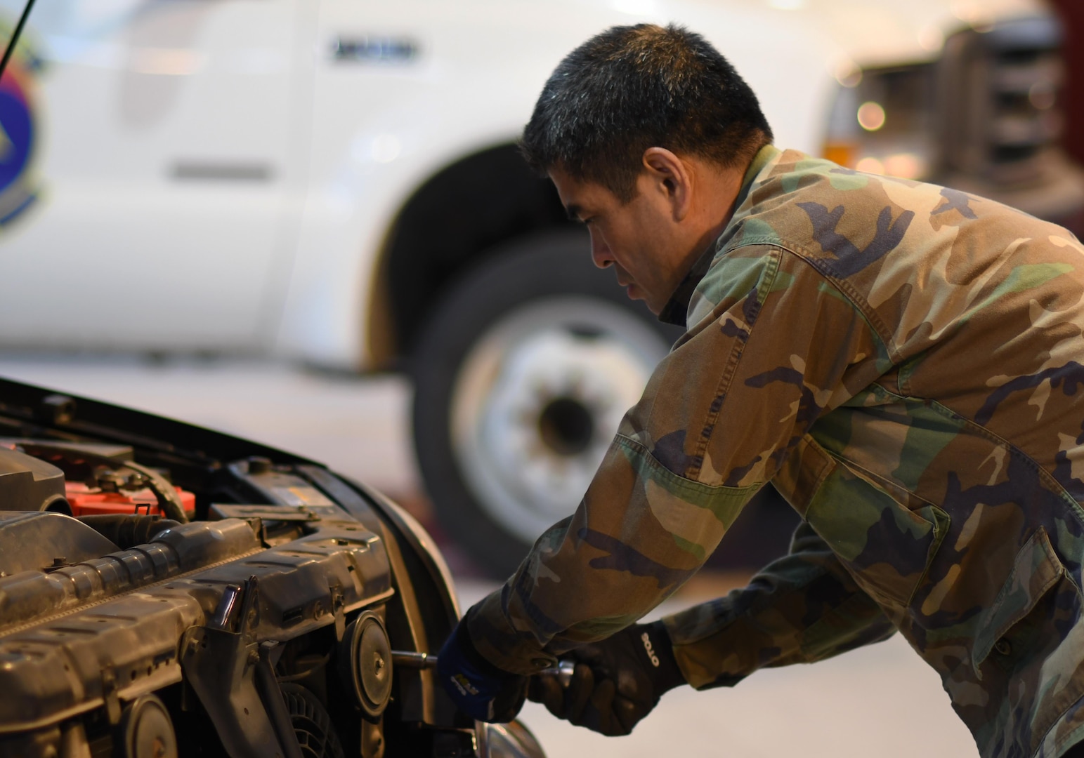 Yi Si-chun, 51st Logistics Readiness Squadron technician, secures a headlight in place at the Vehicle Maintenance Shop on Osan Air Base, Republic of Korea, March 22, 2017. With just over 100 members, Vehicle Maintenance cares for roughly 1,300 vehicles, providing everything from oil changes to engine rebuilds.  (U.S. Air Force photo by Staff Sgt. Alex Fox Echols III/Released)