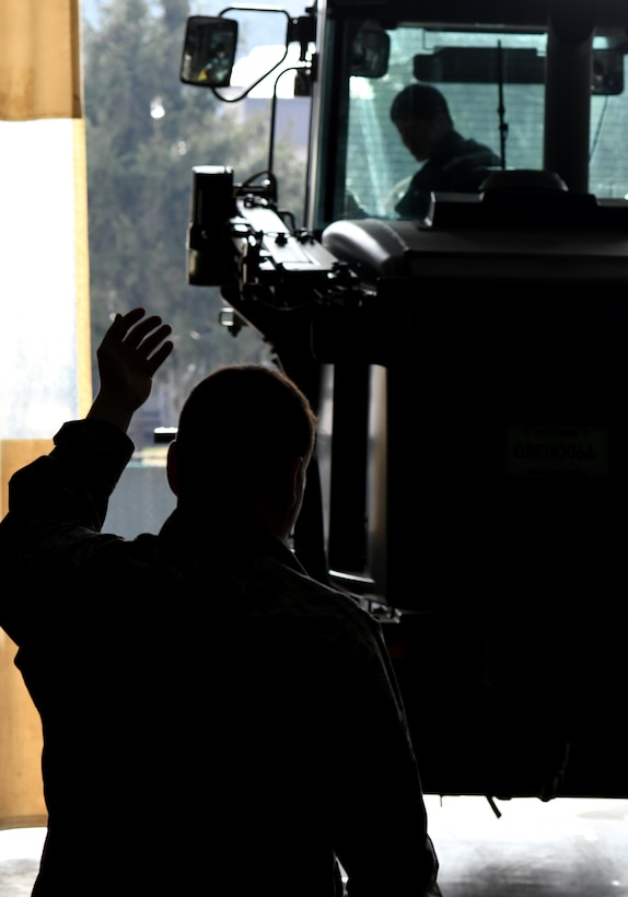 A 51st Logistics Readiness Squadron Airman signals a vehicle into the sanding bay at Osan Air Base, Republic of Korea March 22, 2017. Behind the scenes, 68 Airmen and 38 civilians work together in the Vehicle Maintenance Shop to repair each vehicle as quickly as possible. (U.S. Air Force photo by Staff Sgt. Alex Fox Echols III/Released)