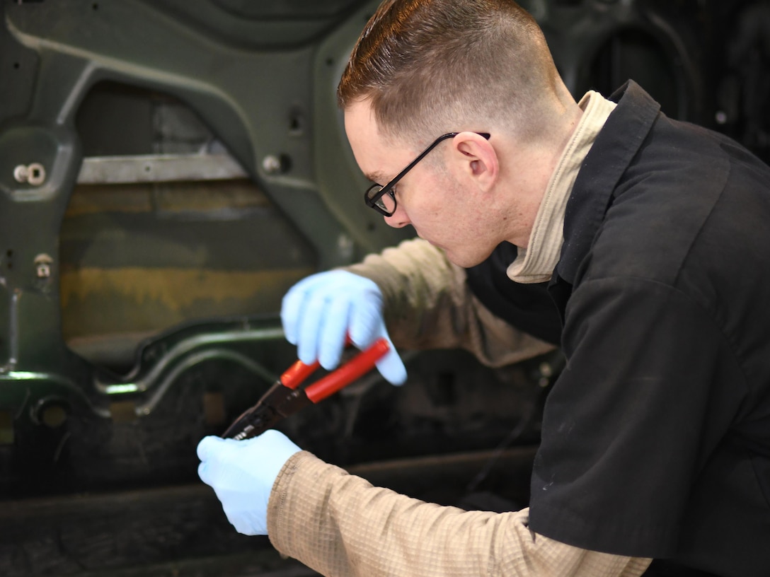 U.S. Air Force Senior Airman Corey Krebs, 51st Logistics Readiness Squadron vehicle maintenance technician, rewires a door sensor connector in the Vehicle Maintenance Shop at Osan Air Base, Republic of Korea, March 23, 2017. With just over 100 members, Vehicle Maintenance cares for roughly 1,300 vehicles, providing everything from oil changes to engine rebuilds.  (U.S. Air Force photo by Staff Sgt. Alex Fox Echols III/Released)