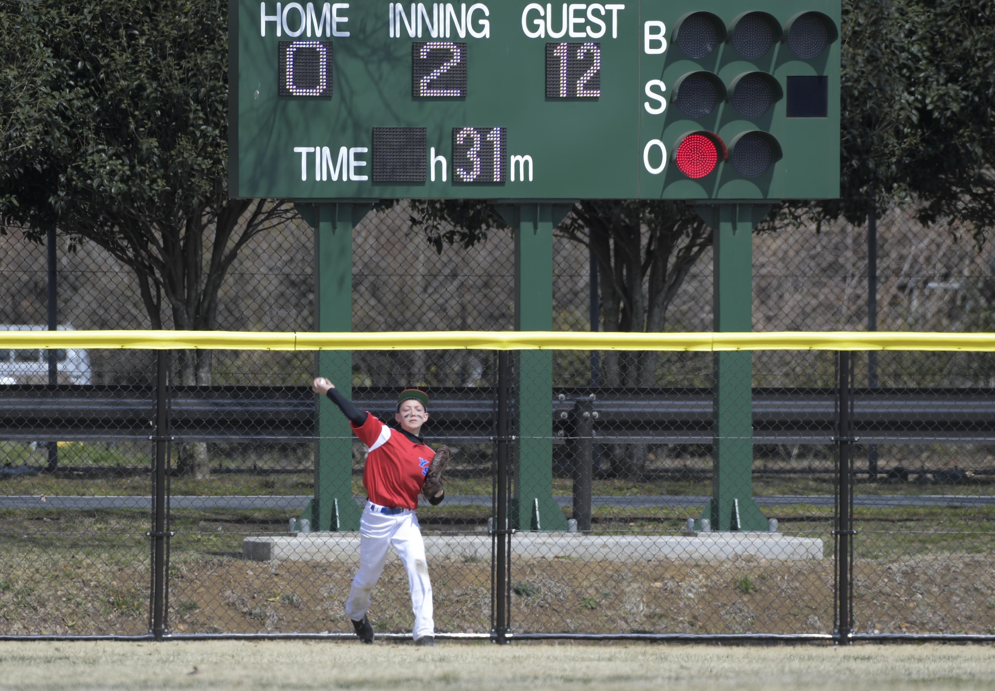 A player from the Yokota Samurai baseball team throws the ball infield during the second inning of the Inaugural Japan-US Friendship Youth Baseball Game against the Chofu Little Seniors team at Yokota Air Base, Japan, March 25, 2017. Chofu scored one of their 30 runs during the inning. (U.S. Air Force photo by Staff Sgt. David Owsianka)
