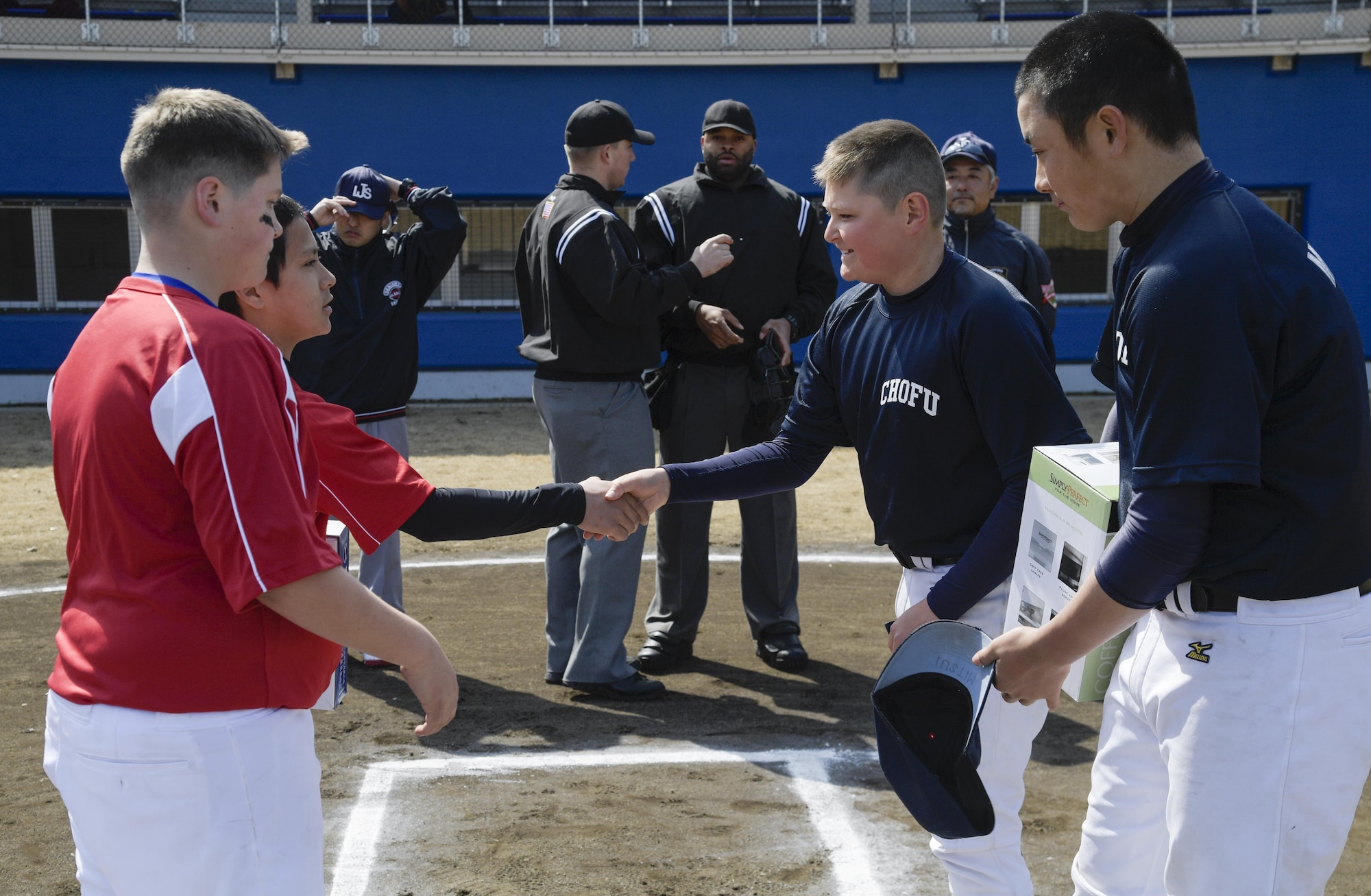 Members of the Chofu Little Seniors and Yokota Samurai baseball teams shake hands prior to the Inaugural Japan-US Friendship Youth Baseball Game at Yokota Air Base, Japan, March 25, 2017. The event marks the beginning of the spring baseball season on base and strengthens ties between the Yokota and Japanese youth through baseball. (U.S. Air Force photo by Staff Sgt. David Owsianka)