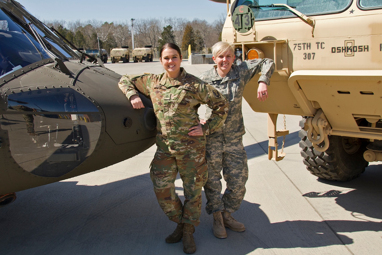 Pfc. Meghan Aube, left, and Staff Sgt. Kathleen Braithwaite stand with the military equipment they maintain on a daily basis. They are two of the few female mechanics in the Kentucky National Guard. 