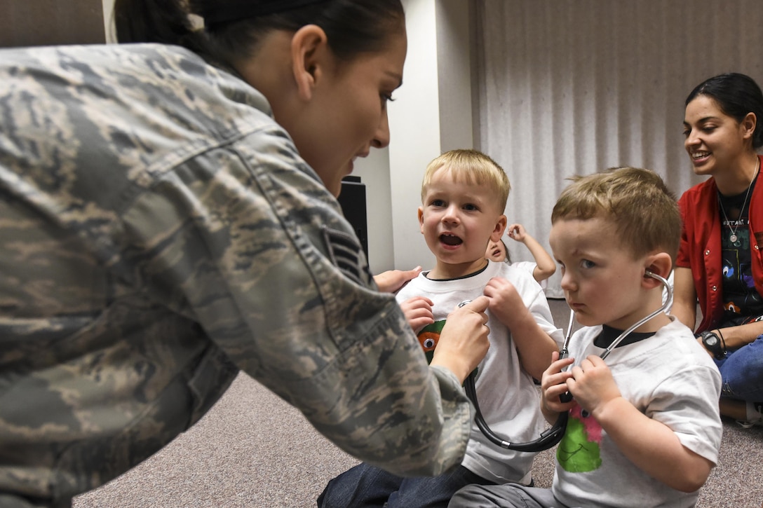 Air Force Senior Airman Elenacorozal Denny teaches children from the 4th Force Support Squadron Child Development Center how to use a stethoscope at Seymour Johnson Air Force Base, N.C., March 21, 2017. The children listened to each other’s heartbeats, read books about the body and toured the pediatric clinic. Air Force photo by Airman 1st Class Victoria Boyton