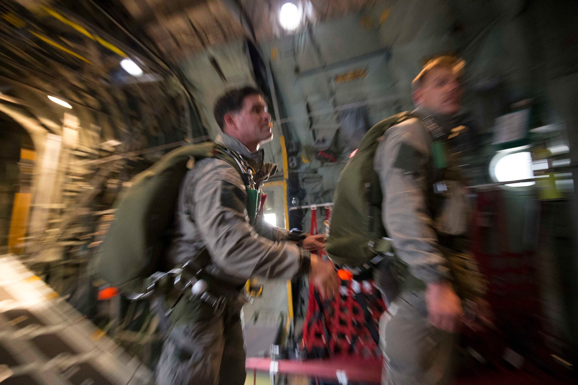U.S. Marines secure a parachute before jump training at Yokota Air Base, Japan, March 23, 2017, during jump week. The training not only allowed the Marines to practice jumping, but it also allowed the Yokota aircrews to practice flight tactics and timed-package drops. (U.S. Air Force photo by Yasuo Osakabe)