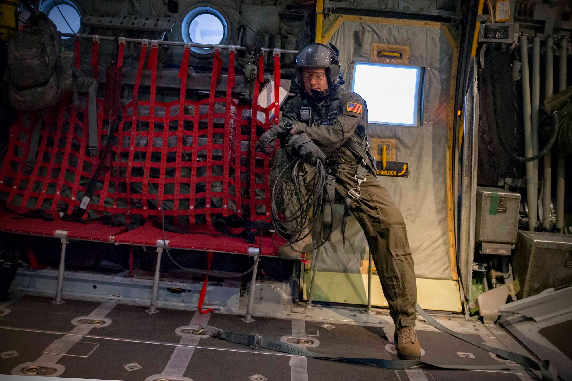 U.S. Air Force Tech. Sgt. Christopher Nichols, 374th Operations Group C-130 loadmaster standardization/evaluation, communicates with aircrews during jump week March 23, 2017, at Yokota Air Base, Japan. The training not only allowed the Marines to practice jumping, but it also allowed the Yokota aircrews to practice flight tactics and timed-package drops. (U.S. Air Force photo by Yasuo Osakabe)