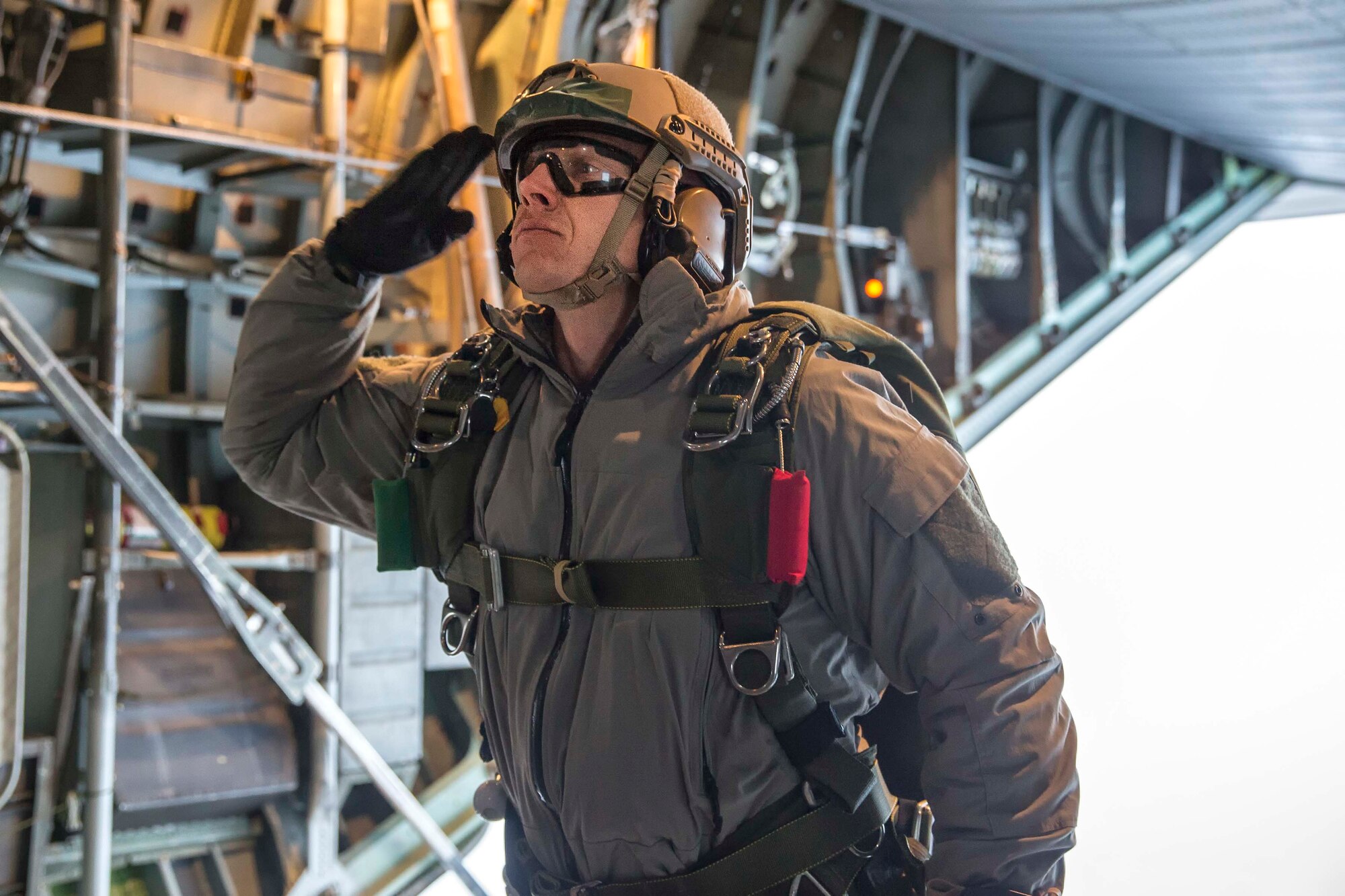 A U.S. Marines with the 3rd Reconnaissance Battalion, 3rd Marine Division, 3rd Marine Expeditionary Force salutes before conducting high altitude – low opening jump over the drop zone in Yokota Air Base, Japan, during jump week, March 23, 2017. The training not only allowed the Marines to practice jumping, but it also allowed the Yokota aircrews to practice flight tactics and timed-package drops. (U.S. Air Force photo by Yasuo Osakabe)