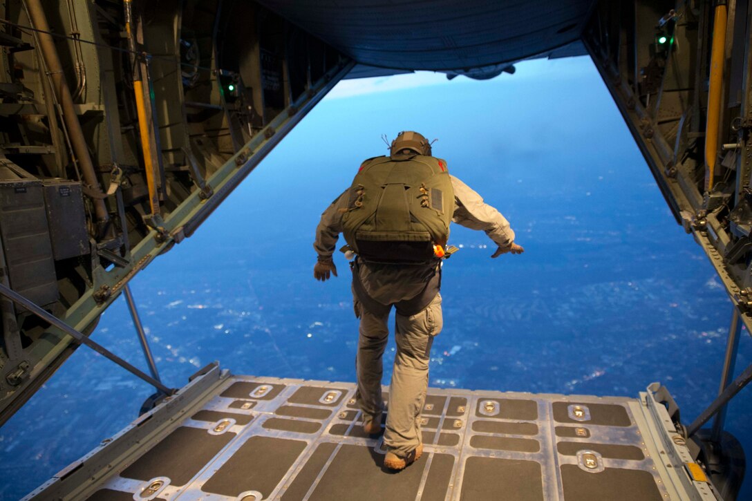 A U.S. Marine conducts high altitude – low opening jump from the back of an Air Force C-130H Hercules aircraft during jump week at Yokota Air Base, Japan, March 23, 2017. The training not only allowed the Marines to practice jumping, but it also allowed the Yokota aircrews to practice flight tactics and timed-package drops day and night. (U.S. Air Force photo by Yasuo Osakabe)