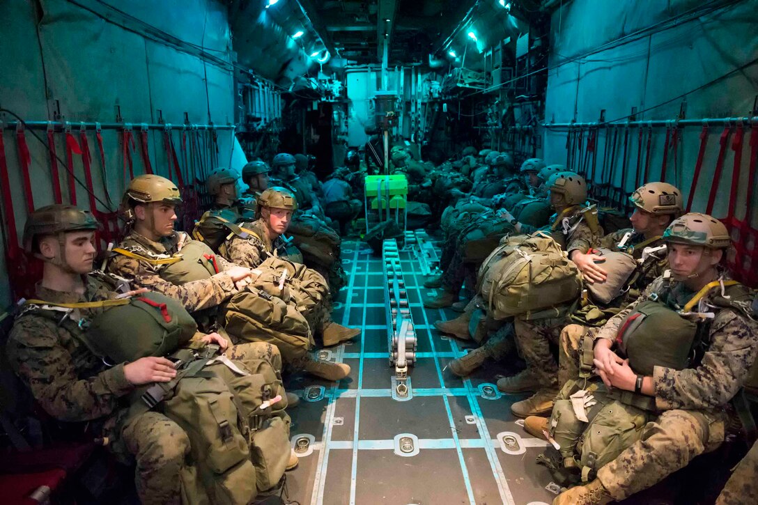 U.S. Marines, assigned to the 3rd Reconnaissance Battalion, 3rd Marine Division, 3rd Marine Expeditionary Force. wait for their jump during an airborne training aboard an Air Force C-130H Hercules during jump week at Yokota Air Base, Japan, March 23, 2017. The Marines are The training not only allowed the Marines to practice jumping, but it also allowed the Yokota aircrews to practice flight tactics and timed-package drops. (U.S. Air Force photo by Yasuo Osakabe)