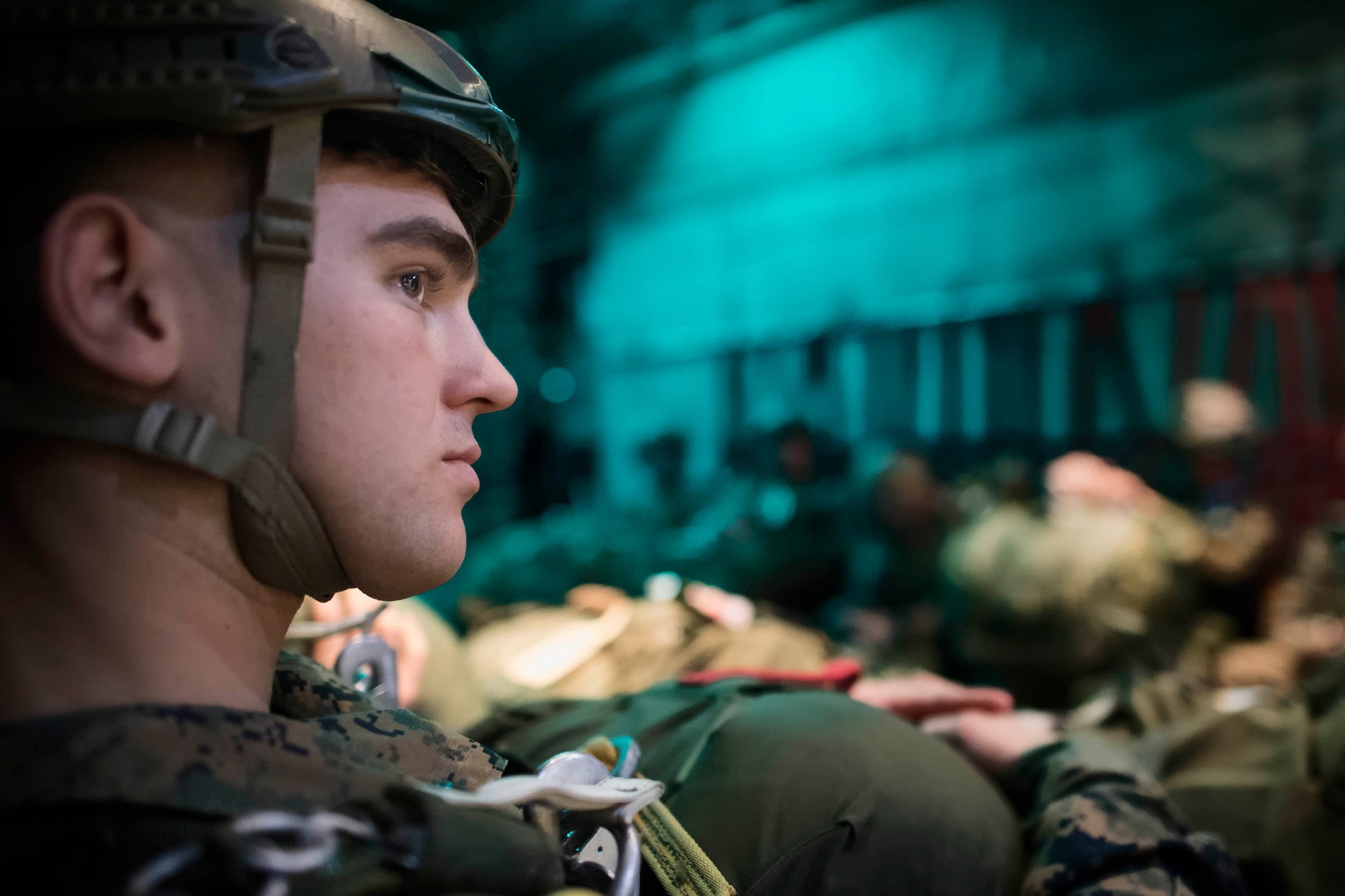 A U.S. Marine, , waits during airborne training aboard an Air Force C-130H Hercules aircraft during jump week at Yokota Air Base, Japan, March 23, 2017. The training not only allowed the Marines to practice jumping, but it also allowed the Yokota aircrews to practice flight tactics and timed-package drops. (U.S. Air Force photo by Yasuo Osakabe)