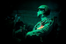 A U.S. Marine gets into his focus before executing personnel drop on an Air Force C-130H Hercules during jump week over Yokota Air Base, Japan, March 23, 2017. The training not only allowed the Marines to practice jumping, but it also allowed the Yokota aircrews to practice flight tactics and timed-package drops day and night. (U.S. Air Force photo by Yasuo Osakabe)