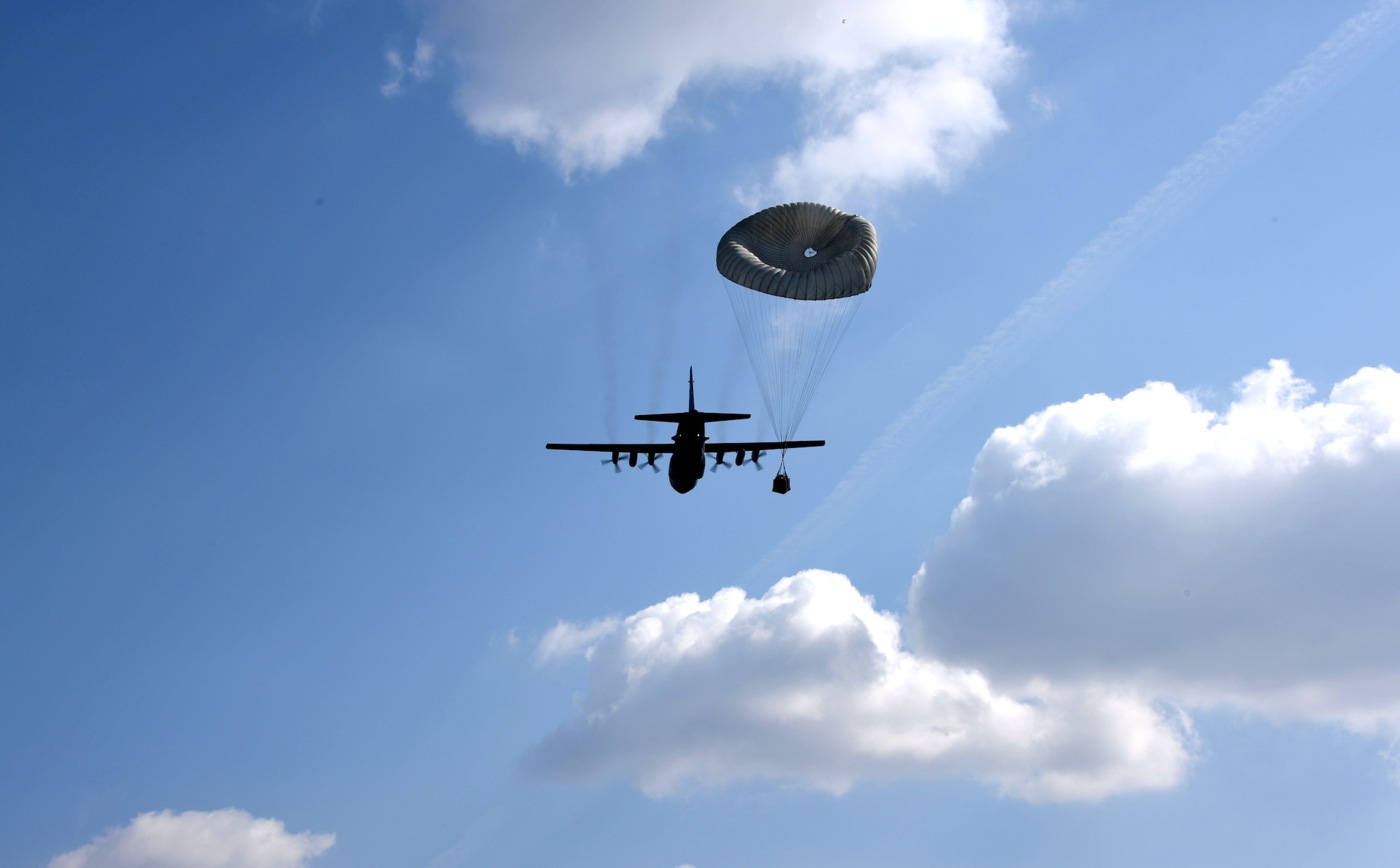 A U.S. C-130 Hercules aircraft conducts an airdrop at Powidz Air Base, Poland, March 24, 2017.  Airmen from the U.S. and Poland participated in bilateral training during Aviation Detachment 17-2 in support of Operation Atlantic Resolve.  These bilateral trainings focused on maintaining joint readiness while building interoperability.  (Air National Guard photo by Staff Sgt. Alonzo Chapman/Released).