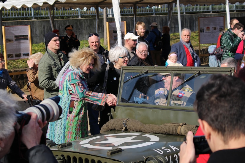 Catherine Rommel, left, the granddaughter of German Field Marshall Erwin Rommel, and Helen Patton, the granddaughter of U.S. Army Gen. George Patton, greet reenactors along the Rhine River Saturday, March 24, 2017 in Nierstein Germany. Americans and Germans gathered for the dedication ceremony for a monument to the 249th Engineer Combat Battalion’s efforts at the end of World War II, building a bridge across the river near Nierstein during an operation that helped shorten the war.