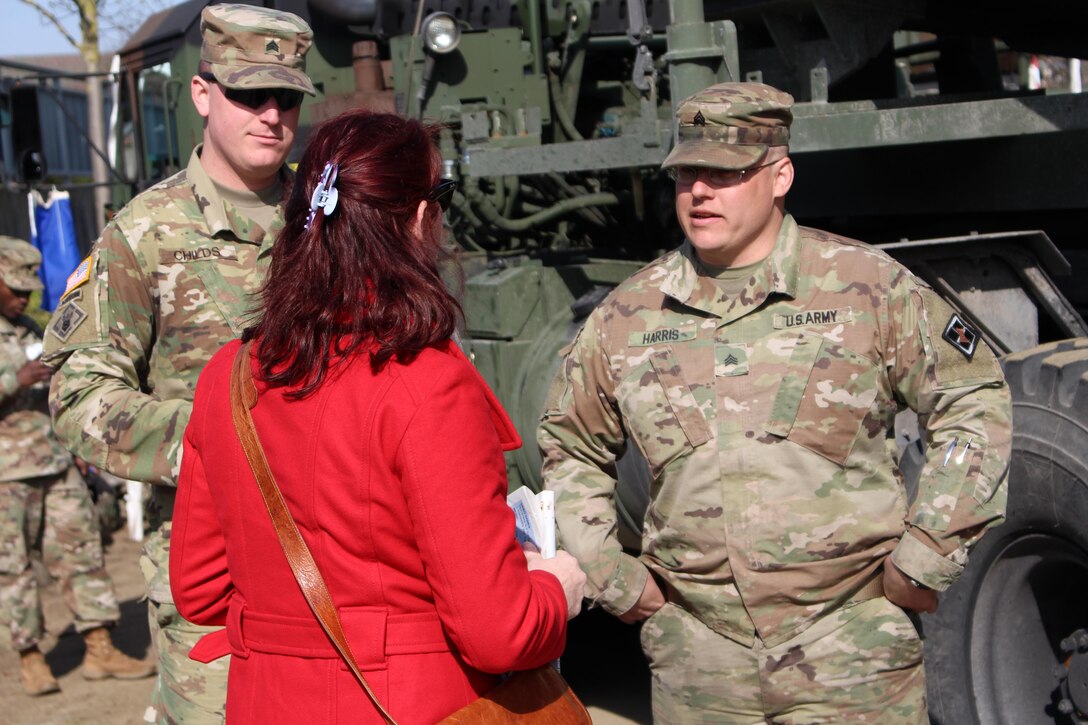 Sgt. Nicholas Childs., of the 15th Engineer Battalion in Grafenwoehr, Germany and Sgt. Matthew Harris, of the Army Reserve’s 361st Engineer Co., from Warner-Robbins, Georgia, speak to passersby along the Rhine River Saturday, March 24, 2017 in Nierstein, Germany. Americans and Germans gathered for the dedication ceremony for a monument to the 249th Engineer Combat Battalion’s efforts at the end of World War II, building a bridge across the river near Nierstein during an operation that helped shorten the war.