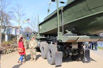 Sgt. Nicholas Childs., of the 15th Engineer Battalion in Grafenwoehr, Germany and Sgt. Matthew Harris, of the Army Reserve’s 361st Engineer Co., from Warner-Robbins, Georgia, speak to passersby along the Rhine River Saturday, March 24, 2017 in Nierstein, Germany. Americans and Germans gathered for the dedication ceremony for a monument to the 249th Engineer Combat Battalion’s efforts at the end of World War II, building a bridge across the river near Nierstein during an operation that helped shorten the war.
