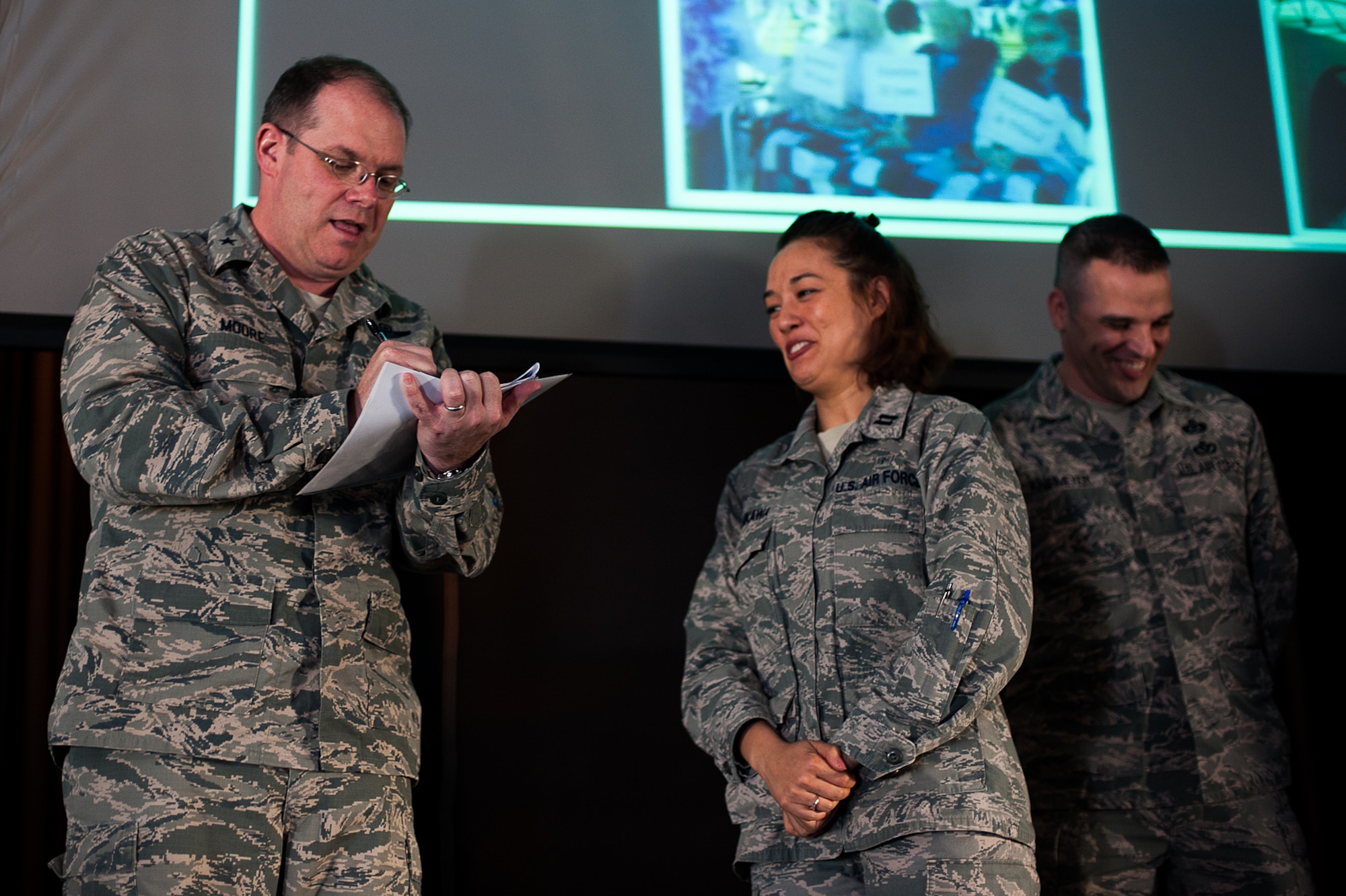 U.S. Air Force Brig. Gen. Richard G. Moore, 86th Airlift Wing Commander, provided the first donation for the Air Force Assistance Fund to Capt. Elba Tanikawa, installation project officer, and Master Sgt. Michael Knipmeyer, assistant installation project officer, at the Hercules Theater on Ramstein Air Base, March 27, 2017. The goal for this year’s campaign is $176,072. (U.S. Air Force photo by Senior Airman Devin Boyer/Released)