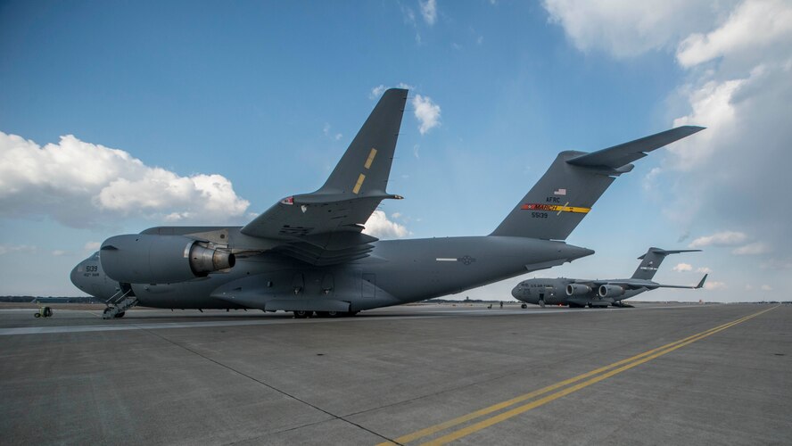Two C-17 Globemaster III's sit on the runway prior to an aeromedical evacuation at Misawa Air Base, Japan, March 22, 2017. The two aircraft, one from March Air Force Base and the other from Travis AFB, both in California, were requested to transport two critical patients to separate locations, Tripler Army Medical Center in Honolulu, and Brooke Army Medical Center at Fort Sam Houston, Texas. (U.S. Air Force photo/Senior Airman Brittany A. Chase)