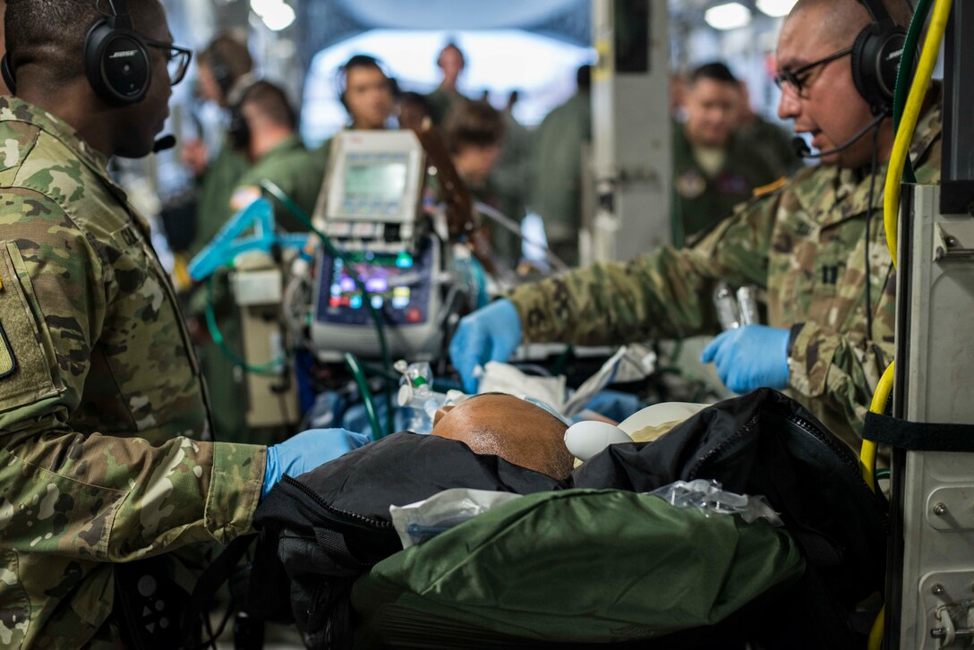 A patient lays on a gurney in a C-17 Globemaster III during an aeromedical evacuation at Misawa Air Force Base, Japan, March 22, 2017. Airmen, Soldiers and U.S. and Japanese Civilian personnel from six different locations around the world teamed up to provide the largest aeromedical evacuation at Misawa AB. (U.S. Air Force photo by Senior Airman Brittany A. Chase)