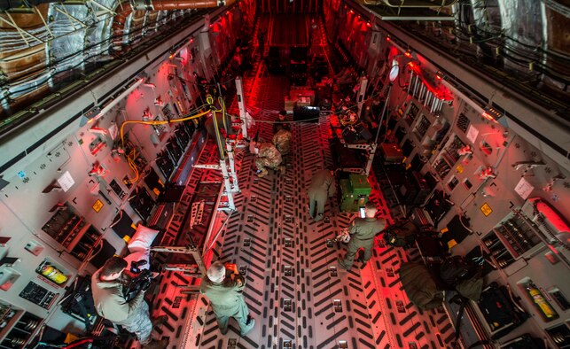 U.S. Airmen from Brooke Army Medical Center at Fort Sam Houston, Texas and March Air Force Base, Calif., prepare a U.S. Air Force C-17 Globemaster III for an aeromedical evacuation at Misawa Air Base, Japan, March 22, 2017. Airmen, Soldiers and U.S. and Japanese civilian personnel from six different locations around the world teamed up to povide the largest aeromedical evacuation to ever happen at Misawa Air Base. (U.S. Air Force photo by Senior Airman Brittany A. Chase)