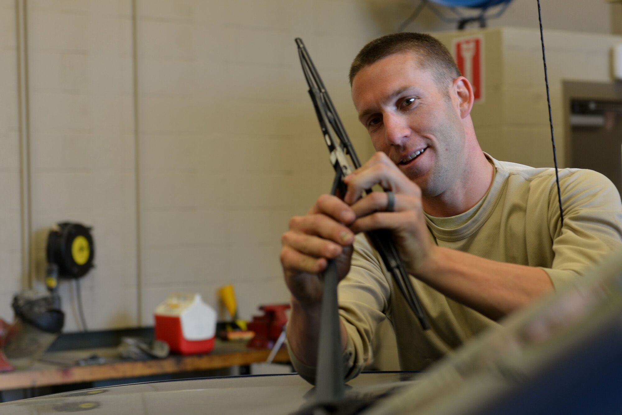U.S. Air Force Staff Sgt. Cody McDonald, 20th Logistics Readiness Squadron customer service noncommissioned officer in charge, replaces windshield wipers on a truck at Shaw Air Force Base, S.C., March 23, 2017. Weather conditions can present visibility hazards while driving if windshield wipers are not properly maintained. (U.S. Air Force Airman 1st Class Destinee Sweeney)