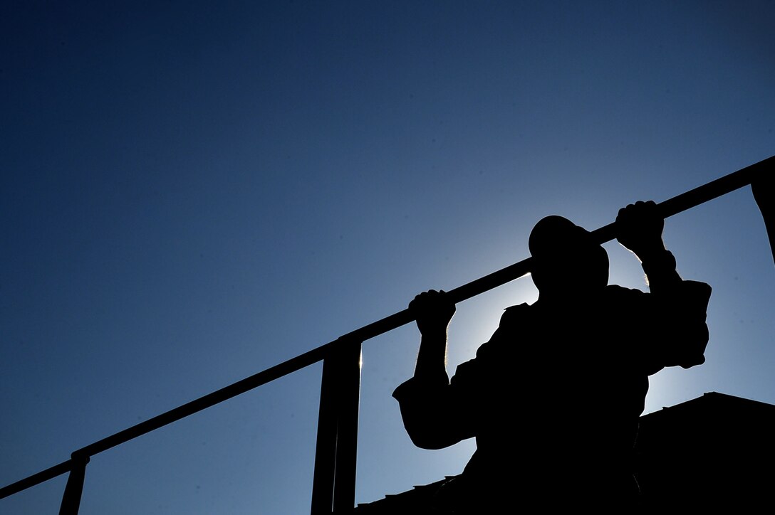 U.S. Air Force Lt. Col. William Clayton, 20th Force Support Squadron commander, performs a pull-up during a 20th Security Forces Squadron Combat Challenge at Shaw Air Force Base, S.C., March 24, 2017. Airmen participated in teams through the challenge and were pushed physically and mentally through a series of obstacles, games and team workouts. (U.S. Air Force photo by Airman 1st Class Christopher Maldonado)