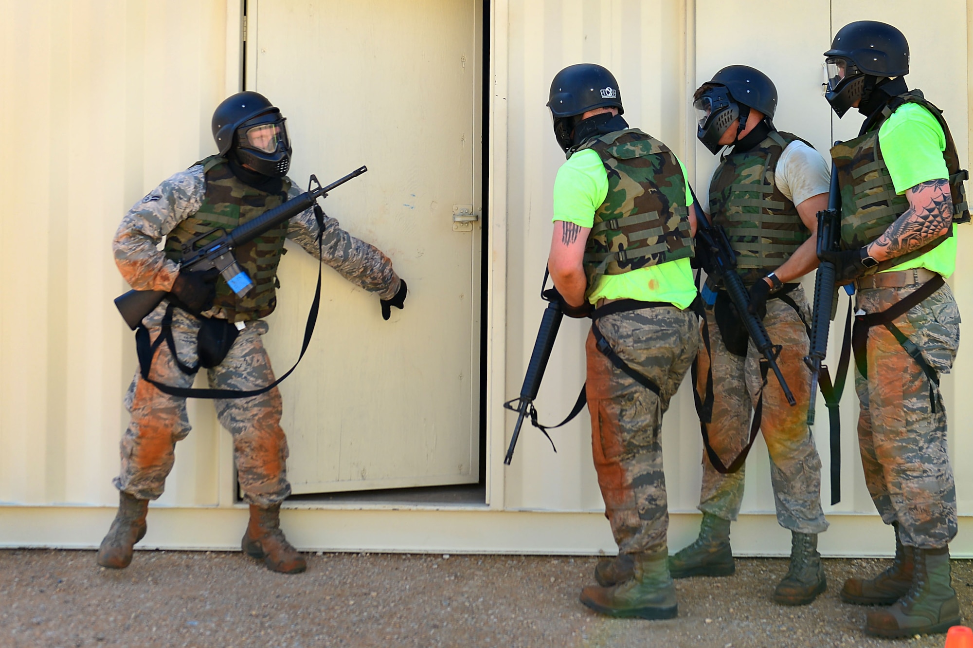 U.S. Airmen assigned to the 20th Component Maintenance Squadron prepare to enter a combat training facility called the “shoot house” during a 20th Security Forces Squadron Combat Challenge at Shaw Air Force Base, S.C., March 24, 2017. Shoot house participants entered a simulated hostile environment where they were required to rescue a victim and neutralize threats.  (U.S. Air Force photo by Airman 1st Class Christopher Maldonado)