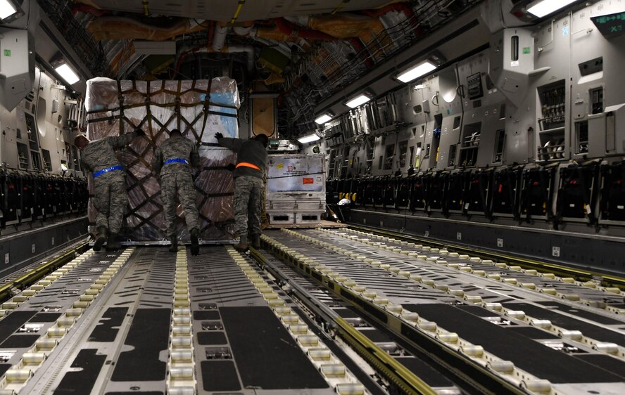 Students of the 721st Aerial Port Squadron’s Unit Learning Center push a pallet of cargo onto a C-17 Globemaster III during hands-on training for the class on Ramstein Air Base, Germany, March 21, 2017. The three-week long course consisted of classroom and hands-on training for passenger services, air freight, and ramp services. (U.S. Air Force photo by Senior Airman Tryphena Mayhugh)