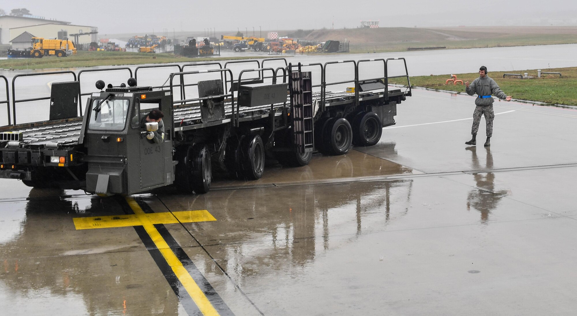 Airman Garrett Johnson, 727th Air Mobility Squadron air transportation technician, marshals a 25k loader away from a C-17 Globemaster III after he and other Airmen loaded cargo onto the aircraft on Ramstein Air Base, Germany, March 21, 2017. Johnson and the other Airmen were students of the 721st Aerial Port Squadron’s Unit Learning Center, which provides 521st Air Mobility Operations Wing Airmen upgrade training for their career field. (U.S. Air Force photo by Senior Airman Tryphena Mayhugh)