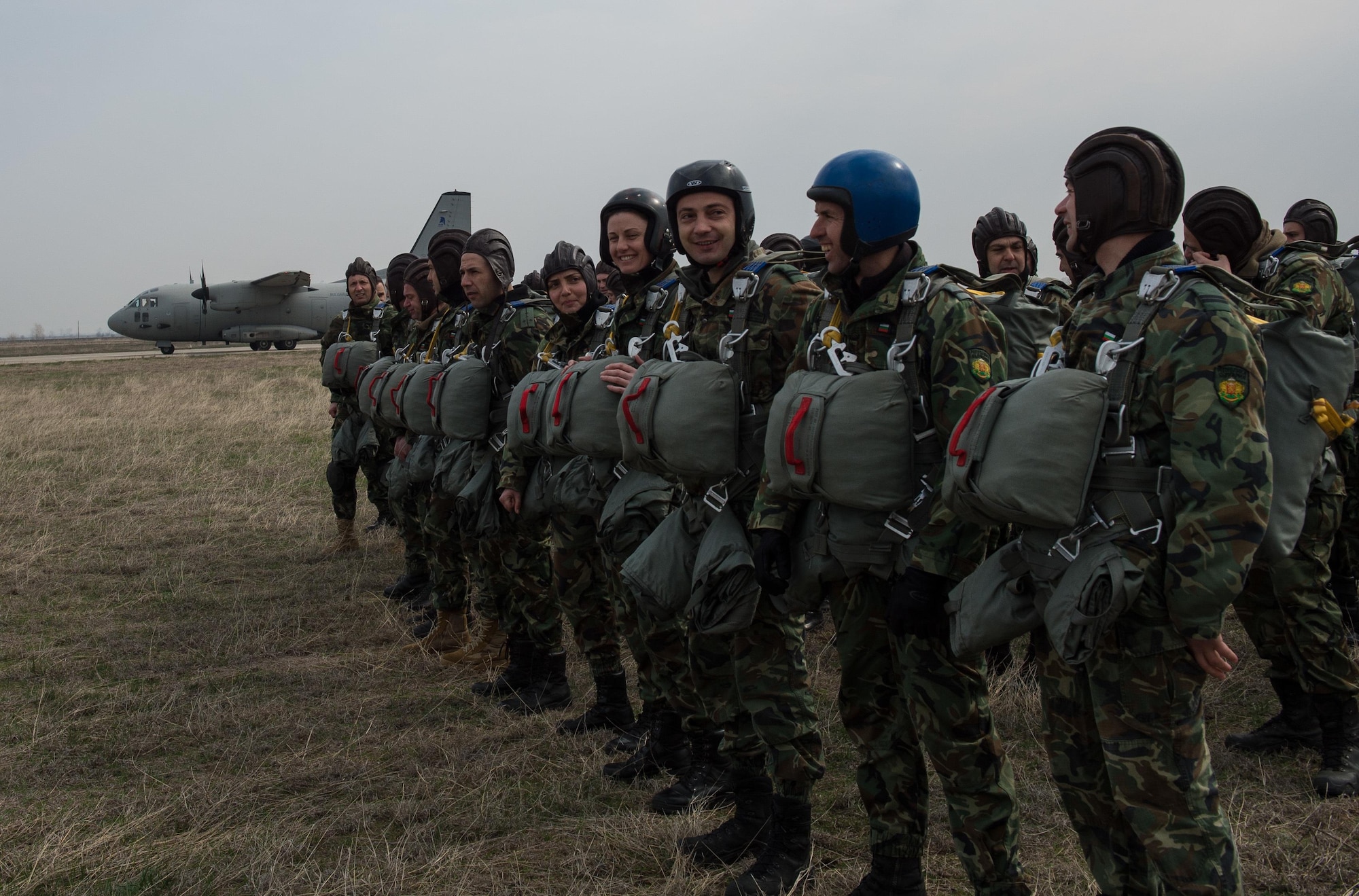 Bulgarian paratroopers wait to load two Super Hercules C-130Js and an Alenia C-27J Spartan during Exercise Thracian Spring 17 over Plovdiv Regional Airport, Bulgaria, March 15, 2017. The 37th AS air crew and 435th Contingency Response Group jump masters from Ramstein Air Base, Germany, worked directly with the paratroopers to conduct tactical flight training. The two-week combined training with Bulgaria’s military aims to facilitate overall relations and build their nations’ joint military capabilities. (U.S. Air Force photo by Staff Sgt. Nesha Humes)