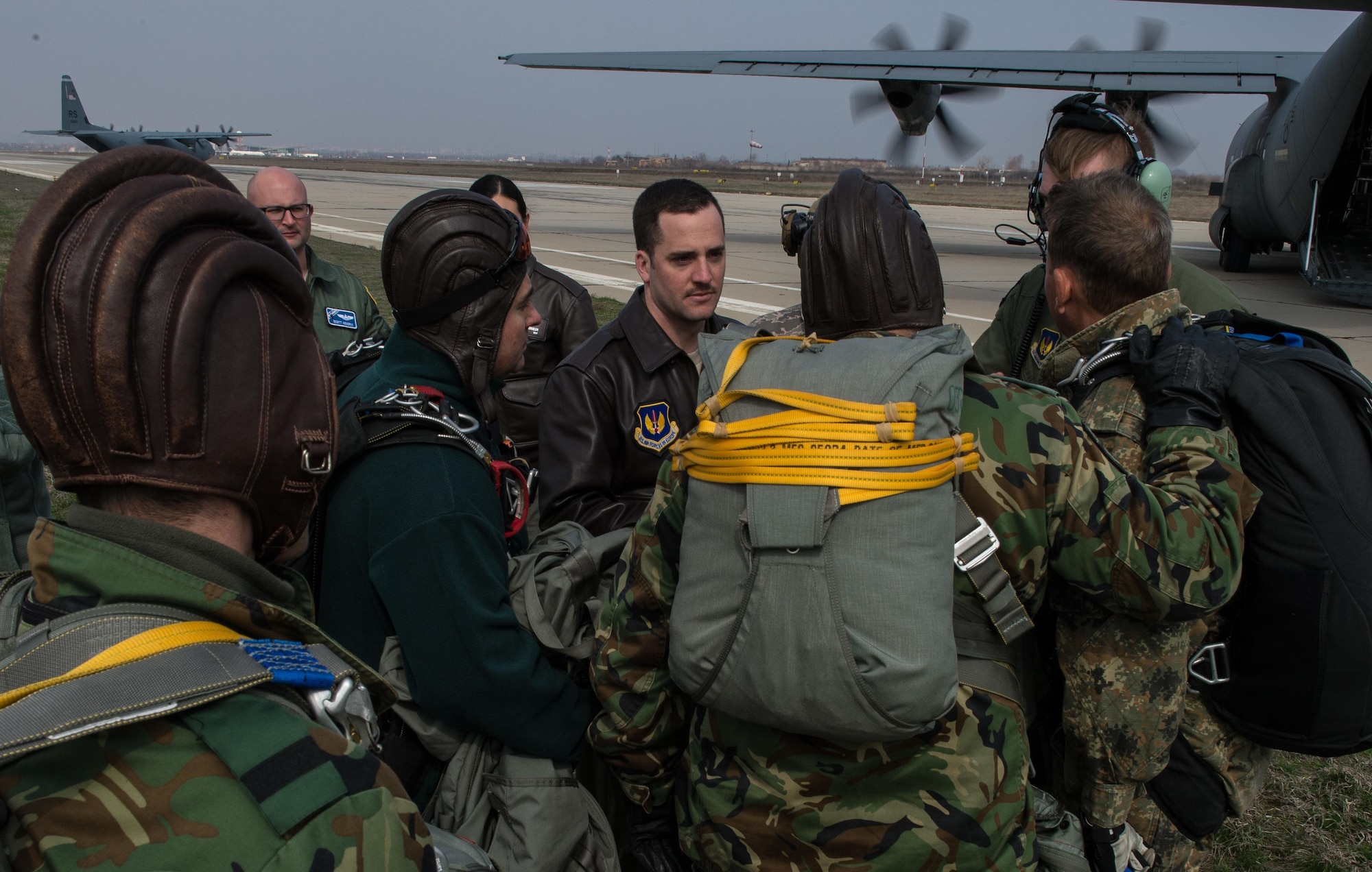 Capt. Tim Vedra, 37th Airlift Squadron C-130J Super Hercules pilot and aircraft commander, discusses an aircraft brief with Bulgarian paratroopers during Exercise Thracian Spring 17 at Plovdiv Regional Airport, Bulgaria, March 15, 2017. The 37th AS air crew and 435th Contingency Response Group jump masters from Ramstein Air Base, Germany, worked directly with the paratroopers to conduct tactical flight training. The training enables the U.S. to maintain a critical mobility hub in support of U.S. training and mission objectives while strengthening relations. (U.S. Air Force photo by Staff Sgt. Nesha Humes)