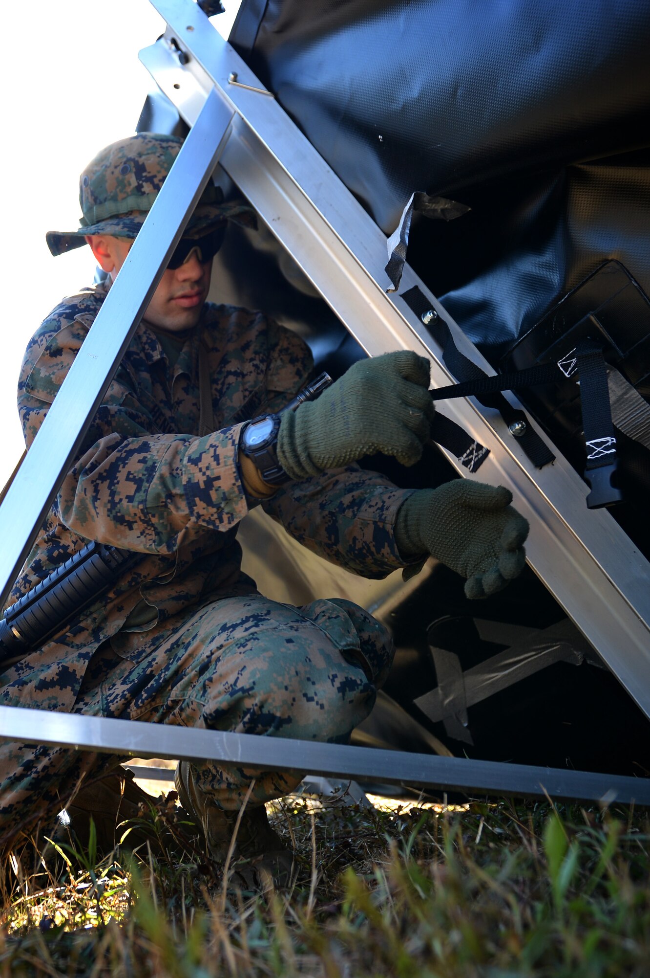 U.S. Marine Corps Pfc. Daniel Henkel, Marine Wing Support Detachment 31 bulk fuel specialist, stationed at Marine Corps Air Station Beaufort, S.C., fastens a restraint on an all-terrain berm at Poinsett Electronic Combat Range near Wedgefield, S.C., March 23, 2017. Defense Department militaries utilize berms as a transportable fuel-holding facility, capable of catching possible fuel leaks in a deployed environment. (U.S. Air Force photo by Airman 1st Class Christopher Maldonado)