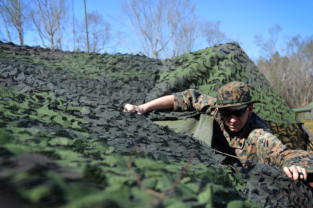 U.S. Marine Corps Sgt. Patrick Knauer, Marine Wing Support Detachment 31 cyber network operator, stationed at Marine Corps Air Station Beaufort, S.C., removes a tent cover at Poinsett Electronic Combat Range near Wedgefield, S.C., March 23, 2017. Marines assigned to the detachment constructed a deployment-like community where they performed their respective missions. (U.S. Air Force photo by Airman 1st Class Christopher Maldonado)