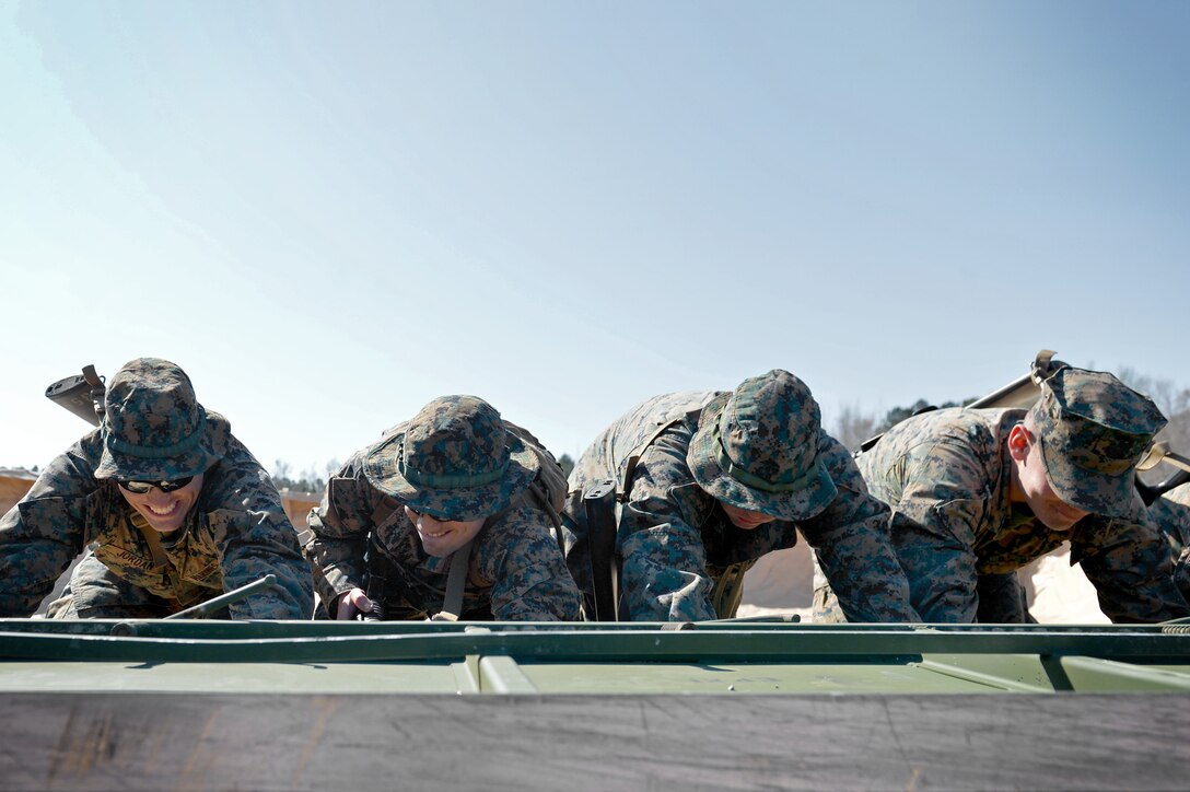 U.S. Marines assigned to Marine Wing Support Detachment 31 stationed at Marine Corps Air Station Beaufort, S.C., push a metal crate at Poinsett Electronic Combat Range near Wedgefield, S.C., March 23, 2017. Poinsett provides a number of opportunities for Defense Department military members to train on bombing and shooting, and offers 12,500 acres for navigation and survival, evasion, resistance, escape training. (U.S. Air Force photo by Airman 1st Class Christopher Maldonado)