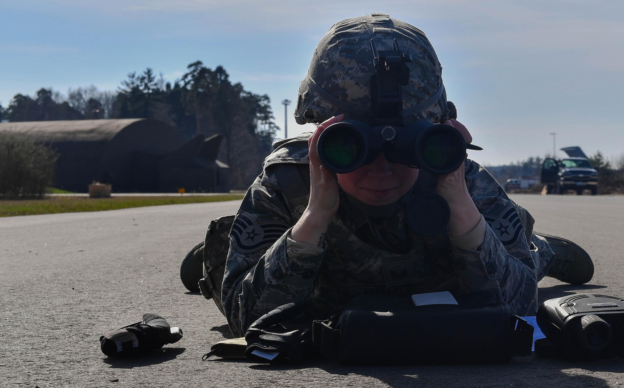 Staff Sgt. Katelyn McHale, 569th U.S. Forces Police Squadron desk sergeant, looks through binoculars to calculate the distance of a target during the range calculation portion of the 435th Security Forces Squadron’s Ground Combat Readiness Training Center’s Security Operations Course on Ramstein Air Base, Germany, March 25, 2017. The purpose of the two-week course is to prepare security forces Airmen who are deploying down range. The purpose of the two-week course is to prepare security forces Airmen who are deploying down range. Airmen assigned to the 86th SFS, 422nd SFS, 100th SFS, and 569th USFPS participated in the course. (U.S. Air Force photo by Senior Airman Tryphena Mayhugh)