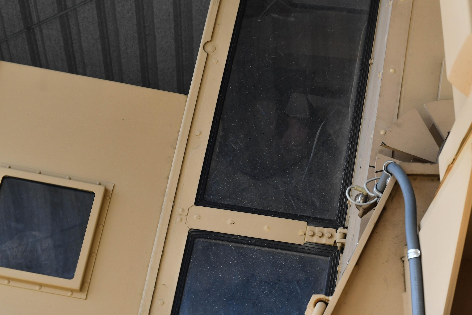 A student of the 435th Security Forces Squadron’s Ground Combat Readiness Training Center’s Security Operations Course sits sideways in a mock Humvee during the Humvee egress training portion of the course on Ramstein Air Base, Germany, March 25, 2017. During the HET portion, students were rolled upside down inside a mock Humvee to prepare them for such a situation while deployed down range. Airmen assigned to the 86th SFS, 422nd SFS, 100th SFS, and 569th U.S. Forces Police Squadron participated in the course. (U.S. Air Force photo by Senior Airman Tryphena Mayhugh)