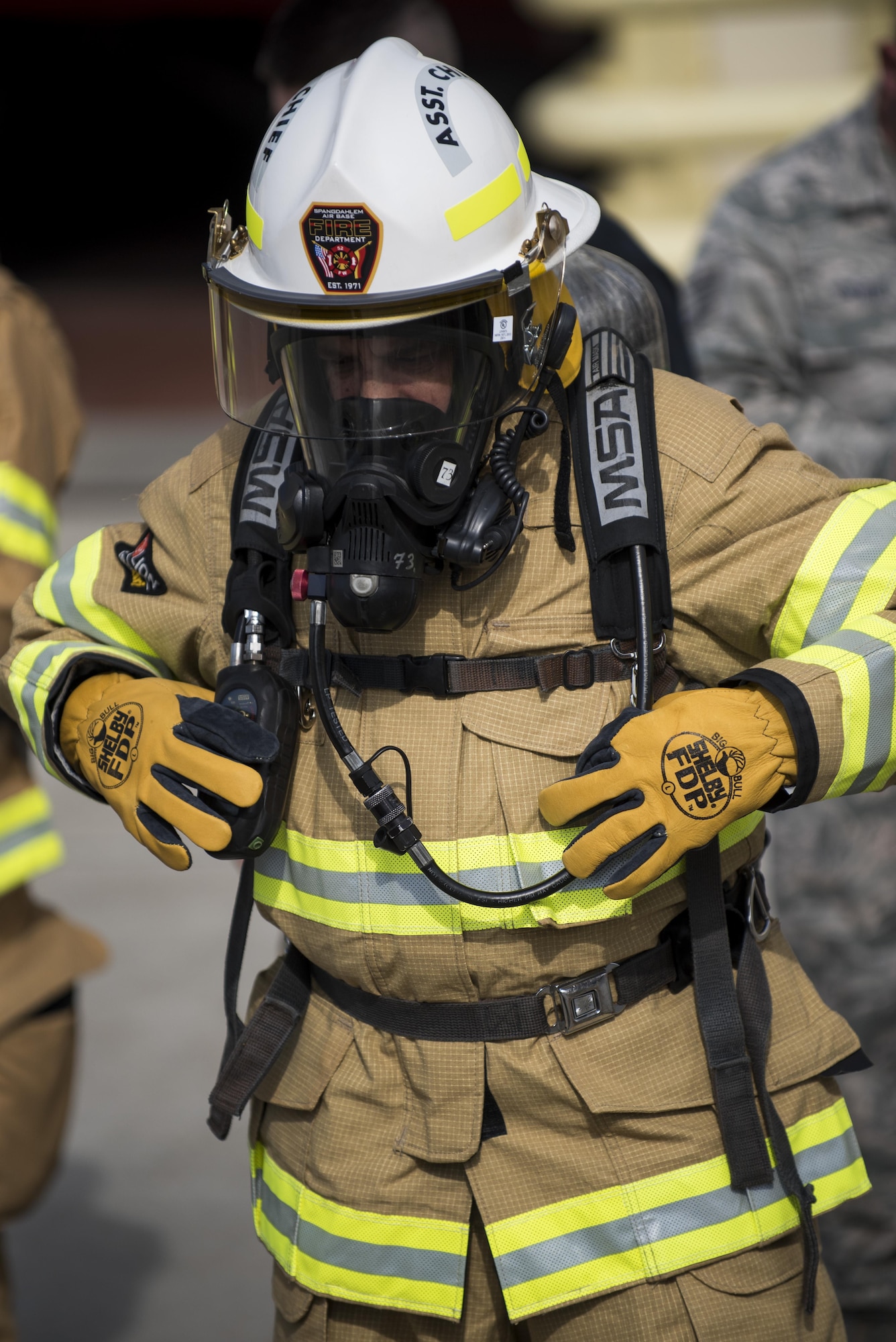 U.S. Air Force Col. Steven Zubowicz, 52nd Mission Support Group commander, makes adjustments to his fire suit before a live fire exercise at Spangdahlem Air Base, Germany, March 23, 2017. MSG leaders were invited to the exercise where firefighters practiced extinguishing various types of fires in a three-room training trailer. (U.S. Air Force photo by Airman 1st Class Preston Cherry)