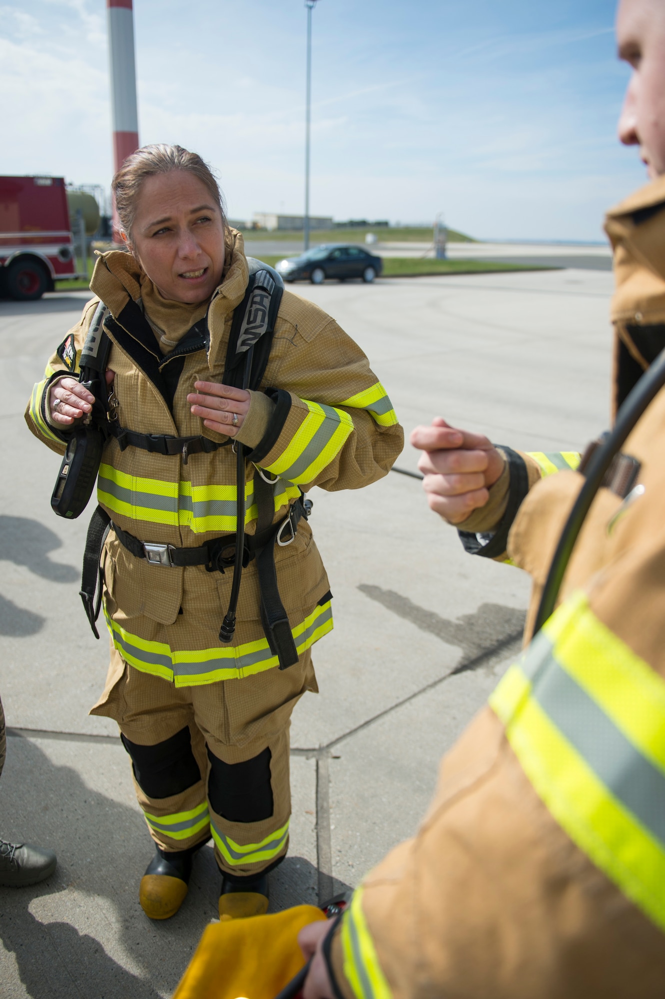 U.S. Air Force Chief Master Sgt. Jennifer Brembah, 52nd Mission Support Group chief enlisted manager, receives instruction from Staff Sgt. Jordan Schraner, 52nd Civil Engineer Squadron firefighter, during a live fire exercise at Spangdahlem Air Base, Germany, March 23, 2017. MSG leadership visited the exercise to experience how Spangdahlem firefighters train and keep their qualifications current. (U.S. Air Force photo by Airman 1st Class Preston Cherry)