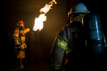 U.S. Air Force Staff Sgt. Jordan Schraner, 52nd Civil Engineer Squadron firefighter, shows Col. Steven Zubowicz, 52nd Mission Support Group commander, a controlled fire during a live fire exercise at Spangdahlem Air Base, Germany, March 23, 2017. The exercise provided firefighters with training such as hose advancement and practice extinguishing various types of fires. (U.S. Air Force photo by Airman 1st Class Preston Cherry)