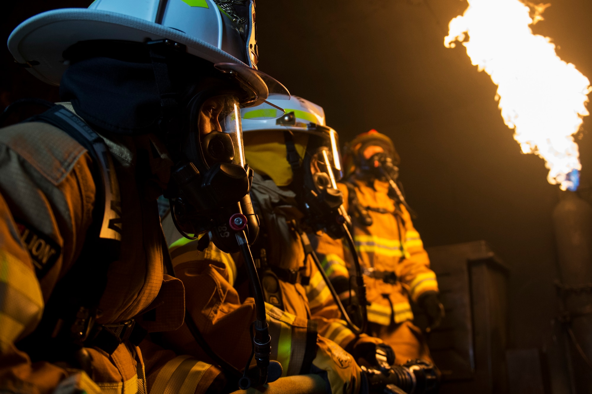 U.S. Air Force Chief Master Sgt. Jennifer Brembah, 52nd Mission Support Group chief enlisted manager, and Col. Steven Zubowicz, 52nd MSG commander, experience a controlled fire during a live fire exercise at Spangdahlem Air Base, Germany, March 23, 2017. The training provided Spangdahlem firefighters with experience in hose advancement and extinguishing various types of fires in a three-room trailer. (U.S. Air Force photo by Airman 1st Class Preston Cherry)