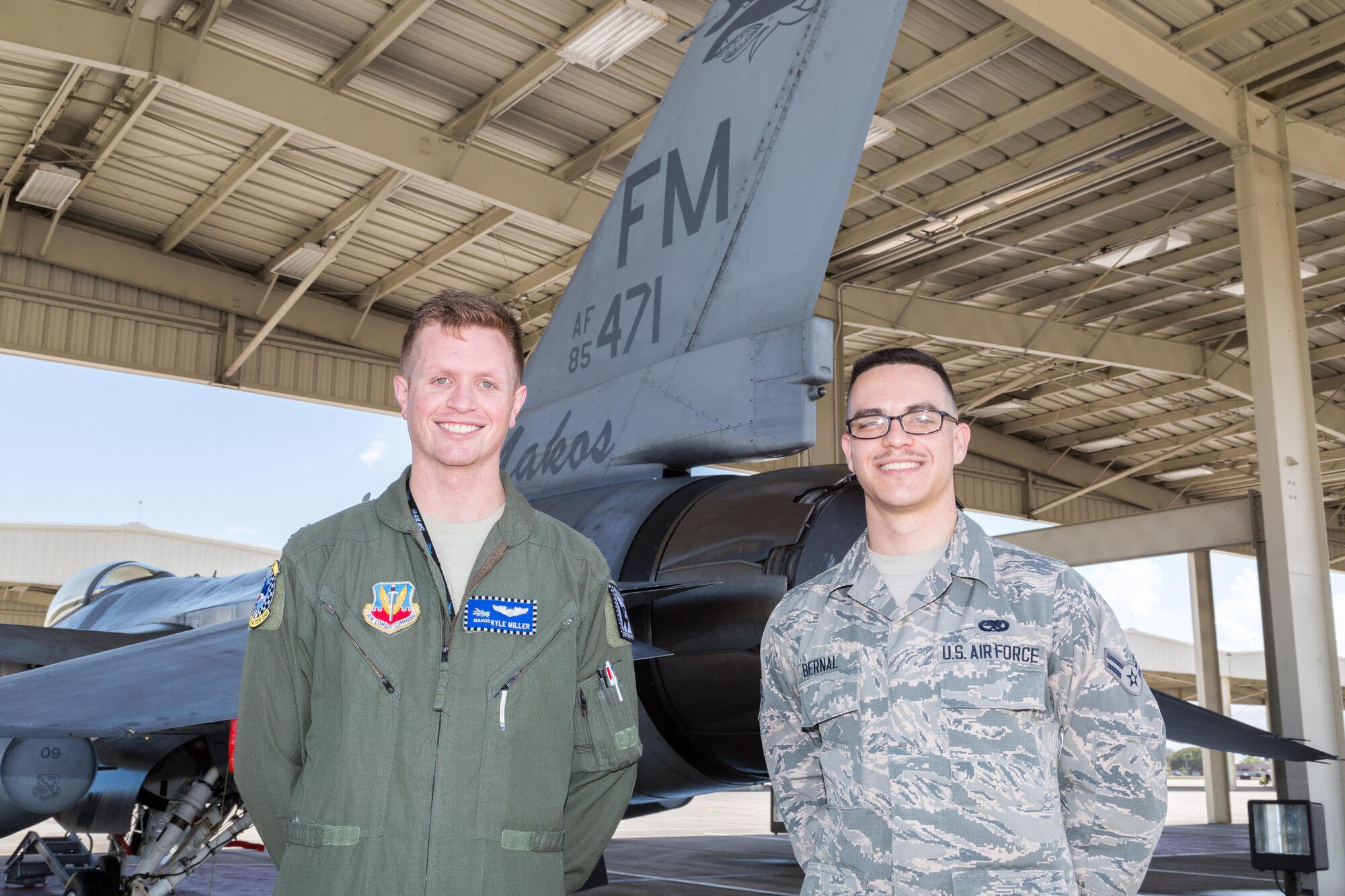 Airman 1st Class Joel Bernal, right, with F-16 pilot and USAFA graduate Capt. Kyle Miller. Bernal an F-16 crew chief with the 482nd Aircraft Maintenance Squadron has been selected as one of approximately 1,000 candidates in the nation to be offered a position in U.S. Air Force Academy's 2021 graduating class. (U.S. Air Force photo/Tech. Sgt. Leo Castellano)
