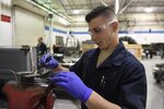 Senior Airman Daniel Angulo-Negron, 4th Equipment Maintenance Squadron aerospace ground equipment technician, examines the bolts on a generator bracket, March 15, 2017, at Seymour Johnson Air Force Base, North Carolina. Repairs, updates and inspections are conducted on the aerospace ground equipment to ensure everything is in proper working order. (U.S. Air Force photo by Airman 1st Class Victoria Boyton) 
