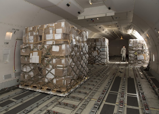 Cargo pallets are loaded into a Kalitta Air Boeing 747 cargo plane by 436th Aerial Port Squadron Airmen March 24, 2017, at Dover Air Force Base, Del. Unlike military airlifters that load cargo from a rear or forward ramp, a Boeing 747 loads cargo through a side door. (U.S. Air Force photo by Senior Airman Zachary Cacicia)