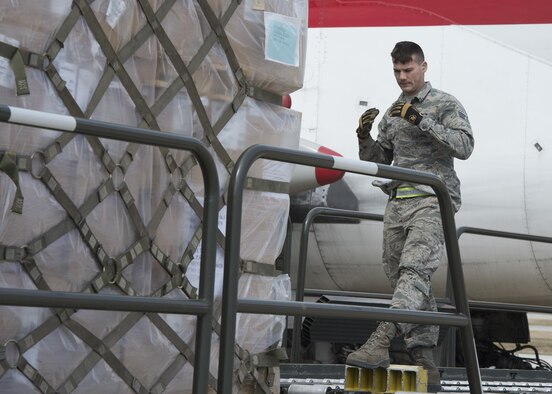 Senior Airman Zachary Parsons, 436th Aerial Port Squadron ramp services, martials a K-Loader during a cargo upload March 24, 2017, at Dover Air Force Base, Del. The 436th APS is the largest aerial port in the Department of Defense, supporting channel, contingency and exercise missions. (U.S. Air Force photo by Senior Airman Zachary Cacicia)