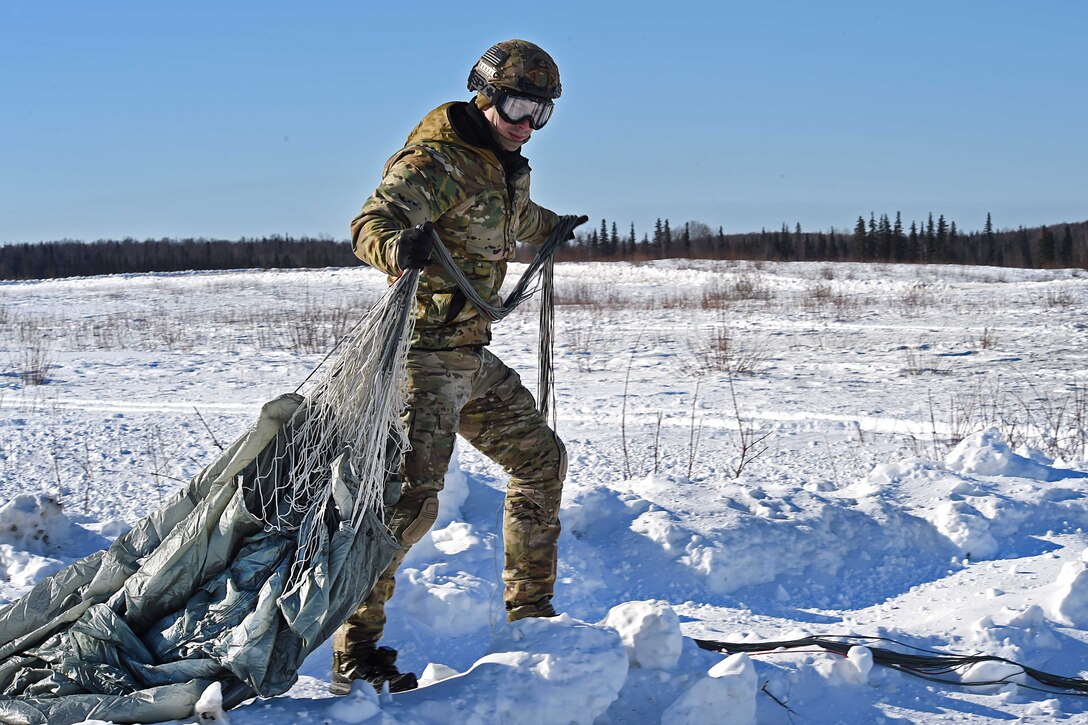 Air Force Staff Sgt. Samuel Gomez recovers his parachute during training at Joint Base Elmendorf-Richardson, Alaska, March 22, 2017. Gomez is a tactical air control party specialist assigned to the 3rd Air Support Operations Squadron. Air Force photo by Airman 1st Class Valerie Monroy