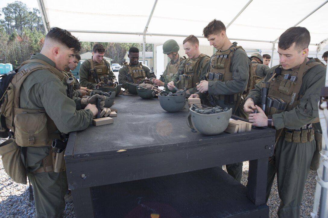 Close Quarters Battle students load ammunition into their magazines for an interior tactics evaluation during Phase II of the CQB course, Feb. 27, aboard Naval Support Activity Northwest Annex, Chesapeake, Va. Students are tested each day during Phase II to ensure they are applying the knowledge and skills the instructors instill in them during the CQB course.  (U.S. Marine Corps photo by Sgt. Kayla D. Rivera/Released.)