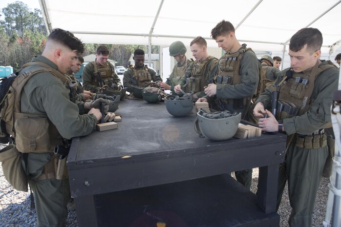 Close Quarters Battle students load ammunition into their magazines for an interior tactics evaluation during Phase II of the CQB course, Feb. 27, aboard Naval Support Activity Northwest Annex, Chesapeake, Va. Students are tested each day during Phase II to ensure they are applying the knowledge and skills the instructors instill in them during the CQB course.  (U.S. Marine Corps photo by Sgt. Kayla D. Rivera/Released.)