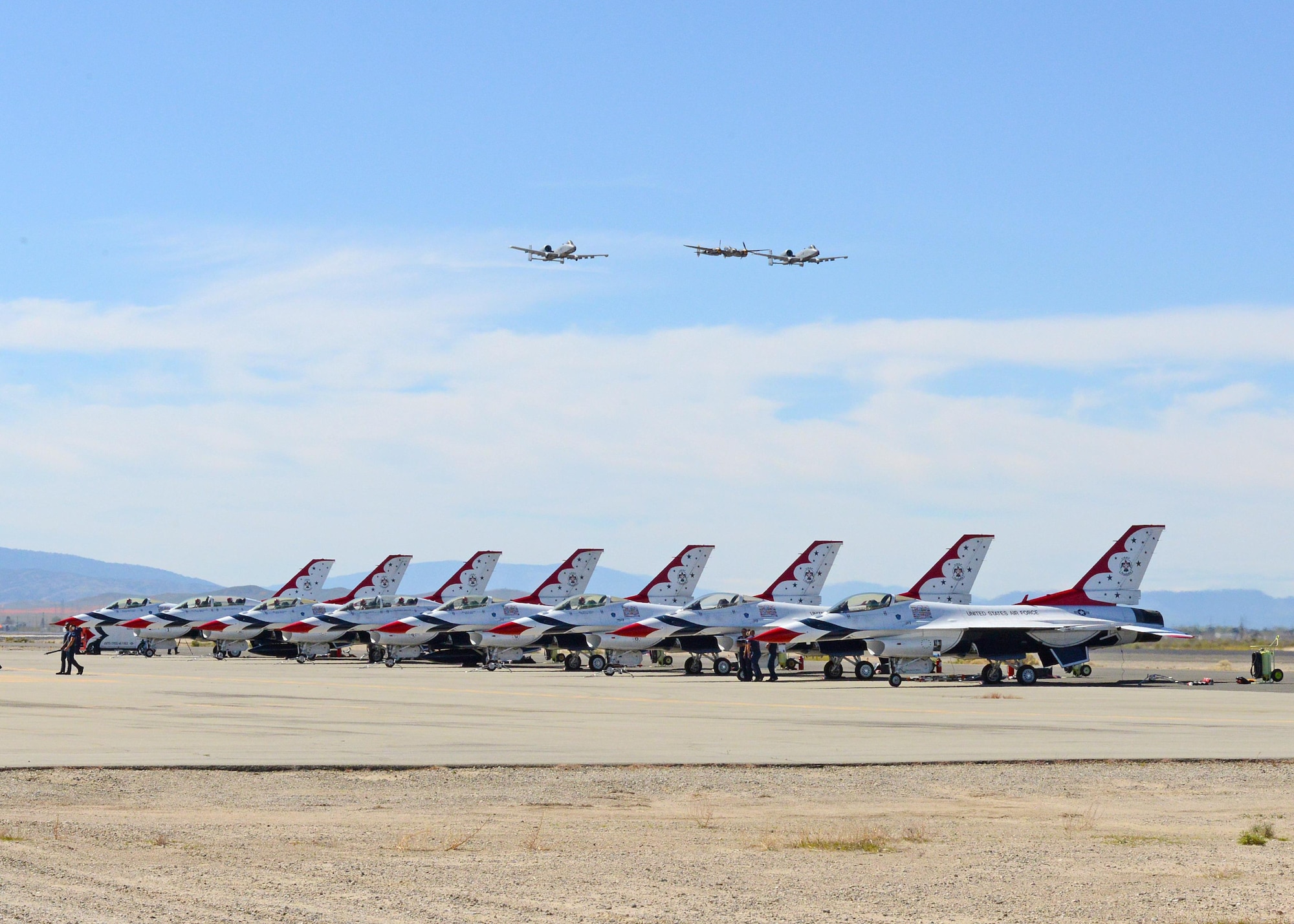 Two A-10 Thunderbolt IIs from the 354th Fighter Squadron out of Davis-Montham Air Force Base, Arizona, participate in a heritiage flight with a P-38J Lightning, which is a World War II-era American fighter aircraft. The plane was provided by the Planes of Fame Air Museum in Chino, California. The trio conducted several passes during a practice session March 24 including this one over the U.S. Air Force Thunderbird Demonstration Team. (U.S. Air Force photo by Kenji Thuloweit)