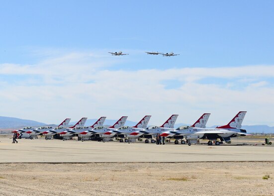 Two A-10 Thunderbolt IIs from the 354th Fighter Squadron out of Davis-Monthan Air Force Base, Arizona, participate in a heritiage flight with a P-38J Lightning, which is a World War II-era American fighter aircraft. The plane was provided by the Planes of Fame Air Museum in Chino, California. The trio conducted several passes during a practice session March 24 including this one over the U.S. Air Force Thunderbird Demonstration Team. (U.S. Air Force photo by Kenji Thuloweit)