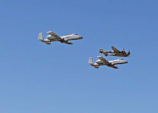Two A-10 Thunderbolt IIs from the 354th Fighter Squadron out of Davis-Monthan Air Force Base, Arizona, participate in a heritiage flight with a P-38J Lightning, which is a World War II-era American fighter aircraft. The plane was provided by the Planes of Fame Air Museum in Chino, California. (U.S. Air Force photo by Kenji Thuloweit)