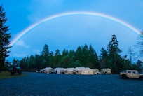 A color spectrum rises above the 301st Maneuver Enhancement Brigade tactical operations center (TOC) at Joint Base Lewis-McChord, Washington, March 11, 2017. Soldiers from the 301st Maneuver Enhancement Brigade went through a series of maneuver and mobility exercises to ensure deployment readiness and demonstrate the brigade’s ability to command and control in a tactical environment. (U.S. Army Reserve photo by Spc. Sean F. Harding/Released).