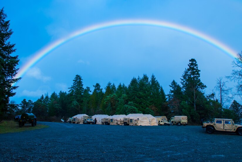 A color spectrum rises above the 301st Maneuver Enhancement Brigade tactical operations center (TOC) at Joint Base Lewis-McChord, Washington, March 11, 2017. Soldiers from the 301st Maneuver Enhancement Brigade went through a series of maneuver and mobility exercises to ensure deployment readiness and demonstrate the brigade’s ability to command and control in a tactical environment. (U.S. Army Reserve photo by Spc. Sean F. Harding/Released).